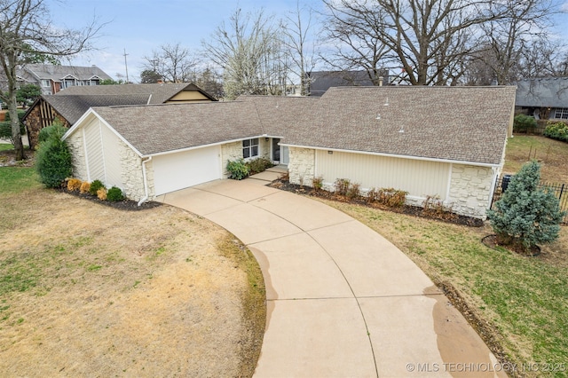 mid-century home with stone siding, concrete driveway, a garage, and a shingled roof