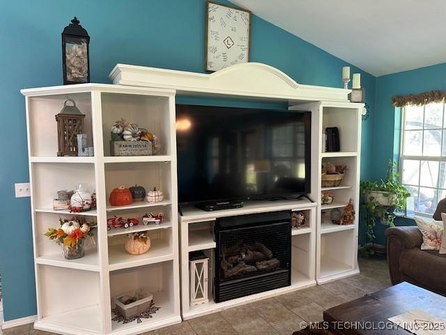 living room featuring lofted ceiling