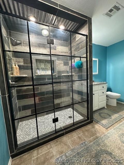 bathroom featuring toilet, vanity, and walk in shower