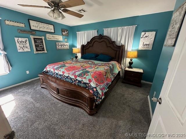 bedroom with dark colored carpet and ceiling fan