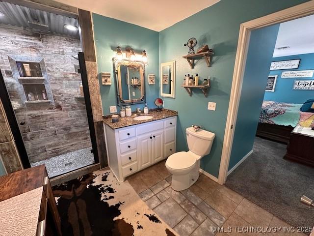 bathroom featuring vanity, toilet, and a shower