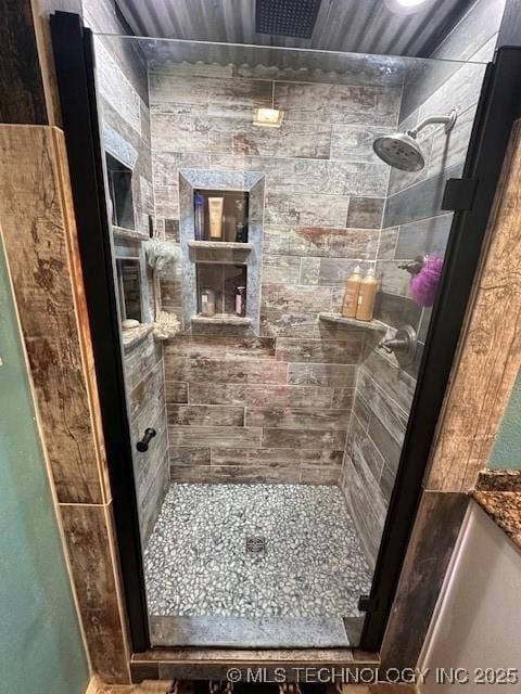 bathroom featuring a shower with shower door