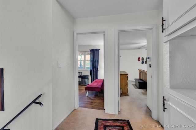 hallway with light colored carpet