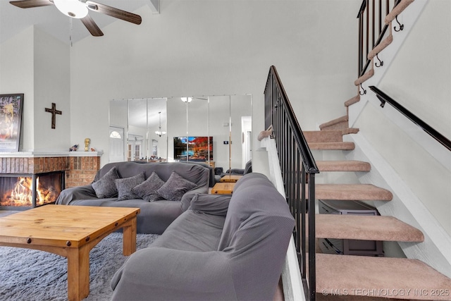 living room featuring a fireplace and ceiling fan