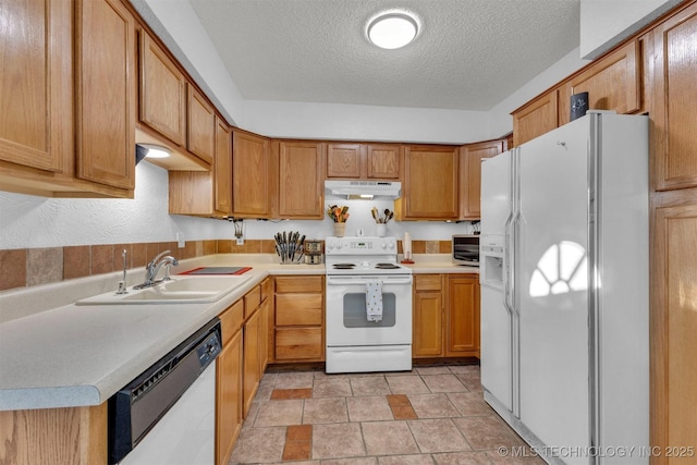 kitchen with white appliances, a textured ceiling, and sink