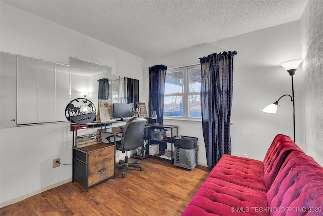 office area with hardwood / wood-style flooring and a textured ceiling