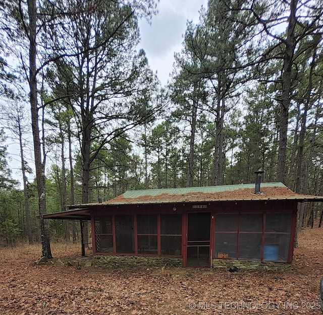 view of outbuilding featuring a sunroom