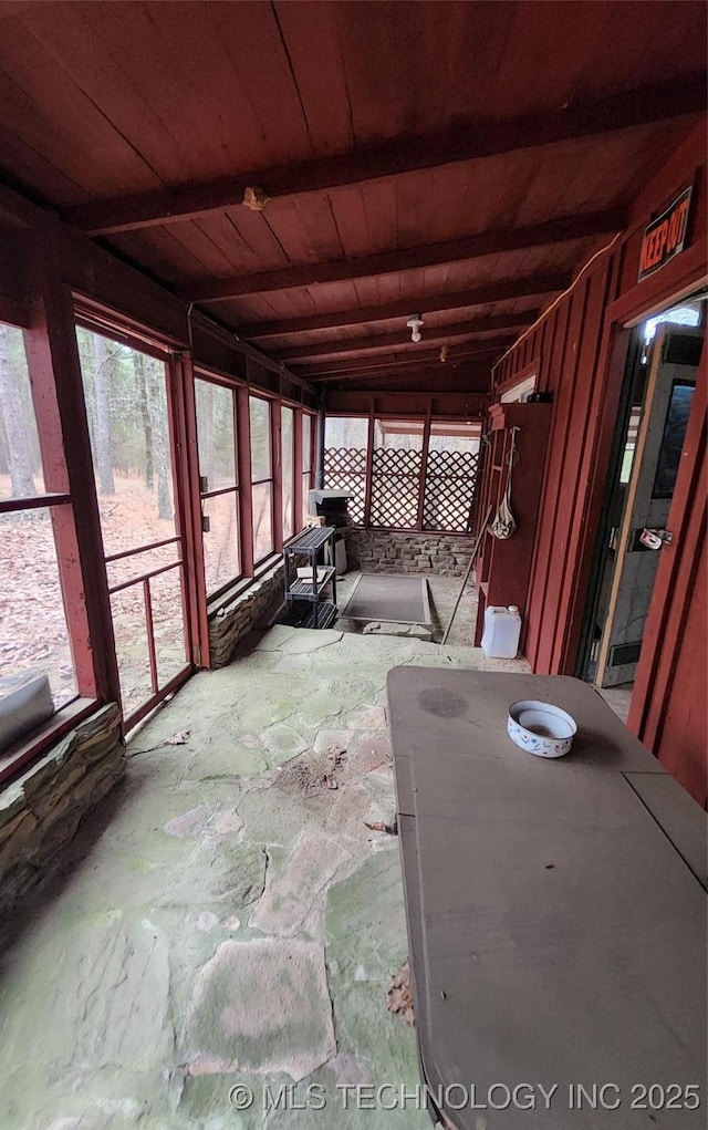 unfurnished sunroom with wooden ceiling