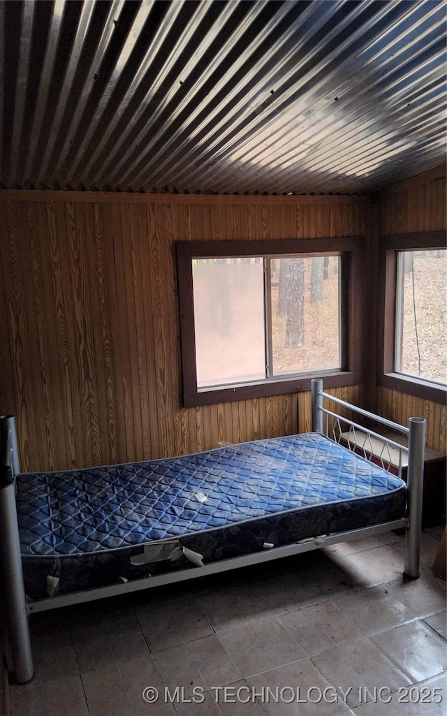 unfurnished bedroom with wood walls