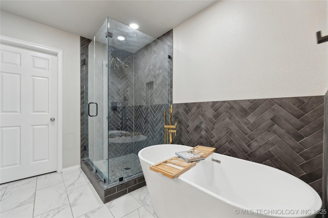 bathroom with plus walk in shower and tile walls