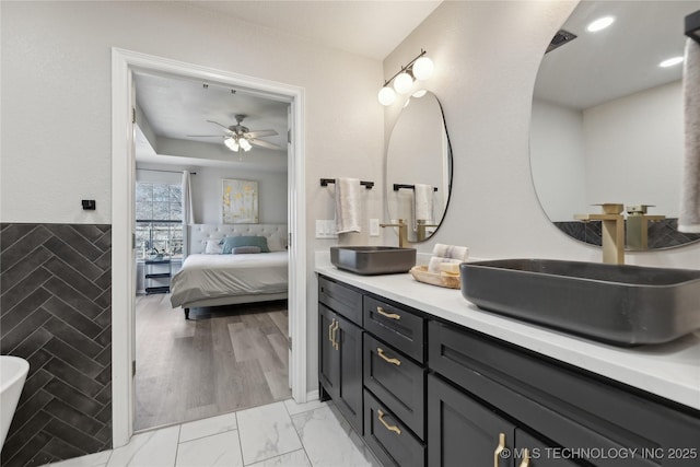 bathroom featuring ceiling fan and vanity