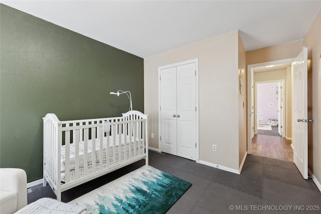 bedroom featuring a crib and a closet