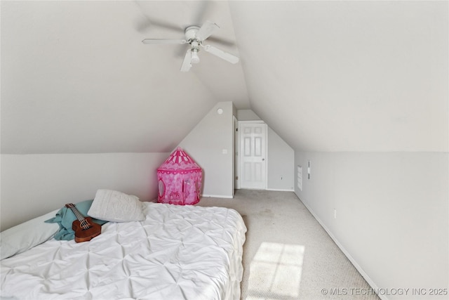 bedroom featuring ceiling fan, lofted ceiling, and light carpet