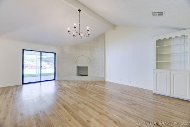 unfurnished living room with a brick fireplace, lofted ceiling with beams, a chandelier, a textured ceiling, and light wood-type flooring