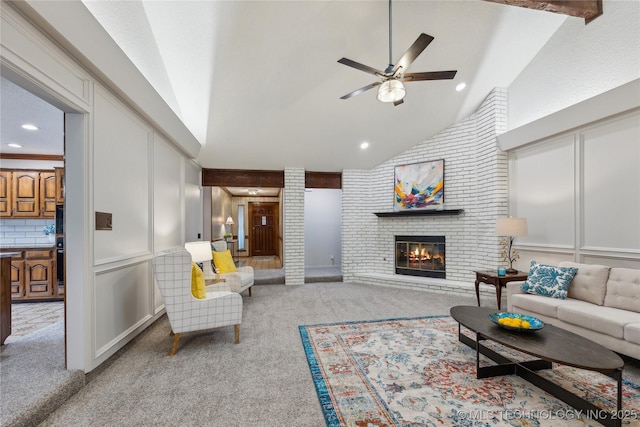 carpeted living room featuring ceiling fan, a fireplace, and high vaulted ceiling