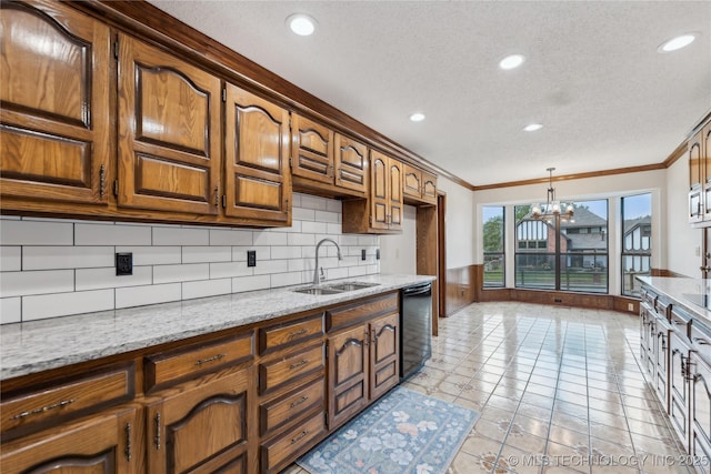 kitchen featuring pendant lighting, sink, black dishwasher, a notable chandelier, and light stone counters