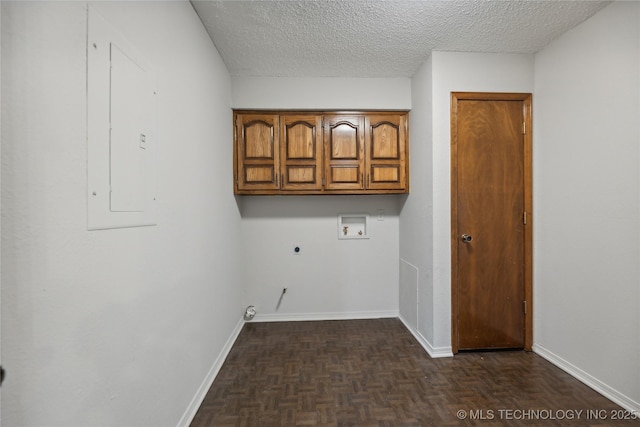 clothes washing area with cabinets, washer hookup, dark parquet flooring, a textured ceiling, and electric dryer hookup