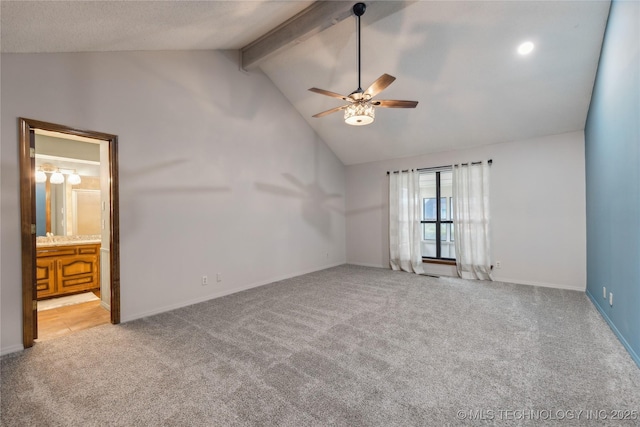 carpeted spare room with vaulted ceiling with beams and ceiling fan