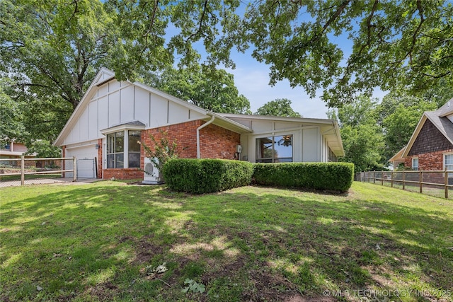 view of front of property with a front lawn and a garage