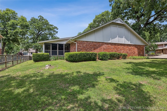 rear view of house with a yard