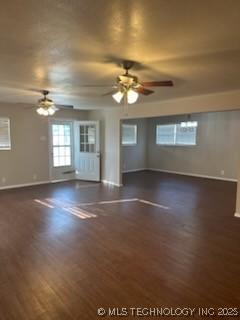 spare room with dark hardwood / wood-style flooring and ceiling fan