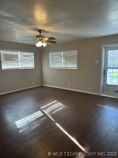 unfurnished room featuring ceiling fan and dark hardwood / wood-style flooring