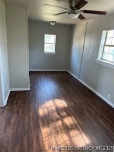 spare room with ceiling fan and dark wood-type flooring