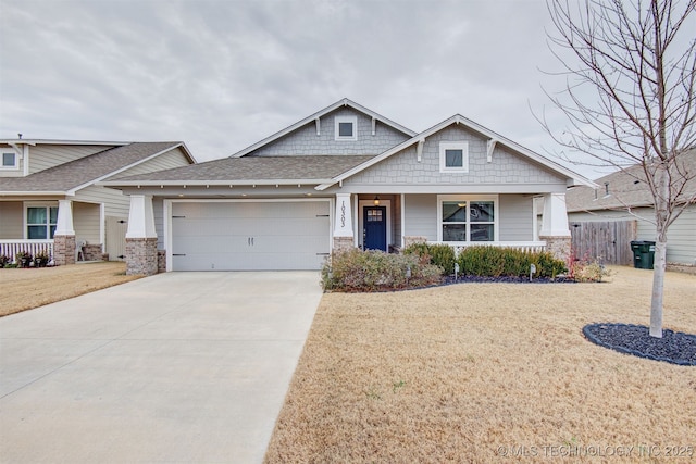 craftsman-style house featuring a front lawn and a garage