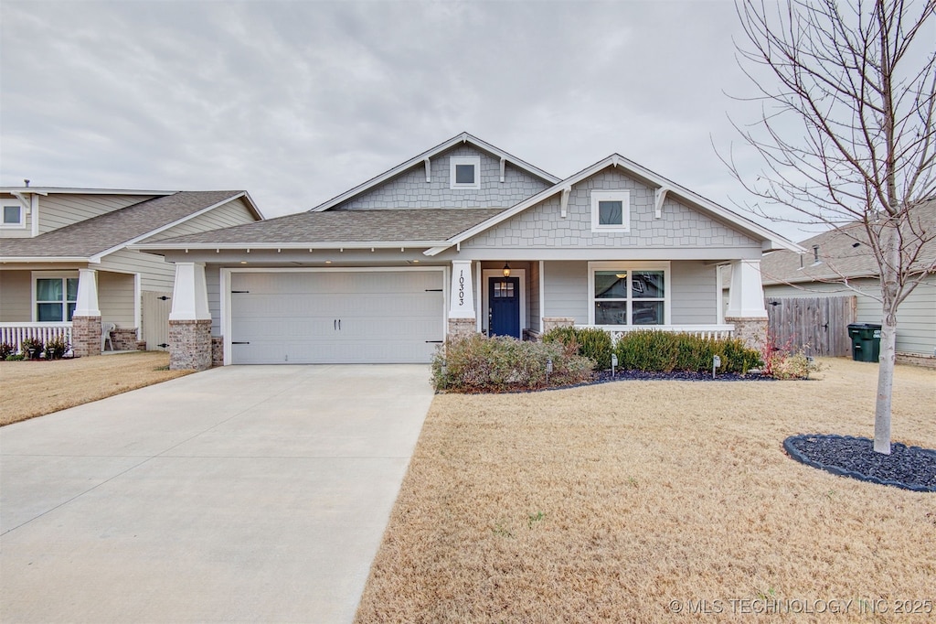 craftsman house with a garage and a front yard