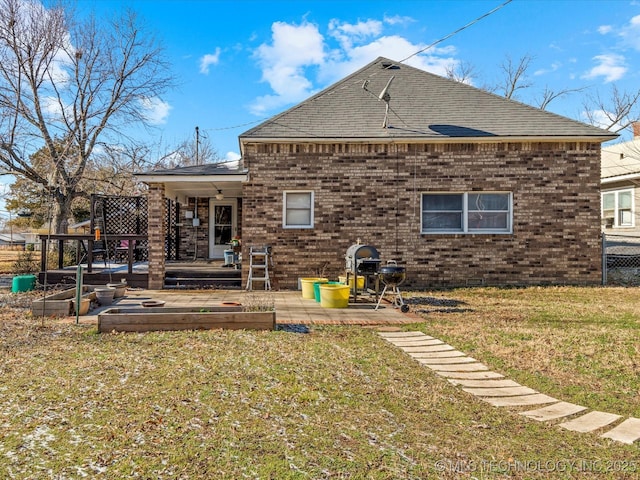 back of property with a patio and a lawn