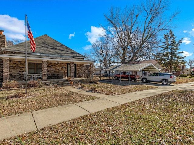 view of yard featuring a carport and a porch