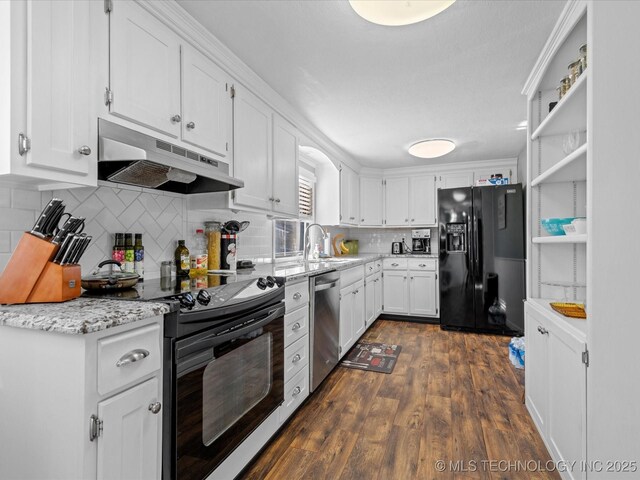 kitchen with black appliances, dark hardwood / wood-style floors, white cabinets, and tasteful backsplash