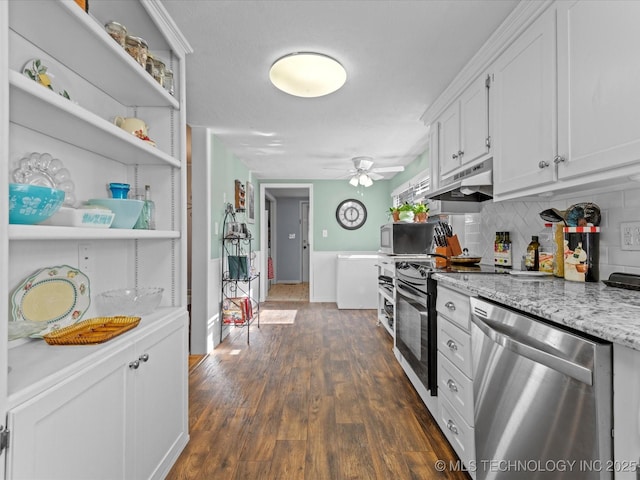 kitchen with tasteful backsplash, light stone counters, stainless steel appliances, dark wood-type flooring, and white cabinets