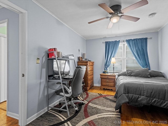 bedroom featuring ceiling fan, hardwood / wood-style floors, and ornamental molding