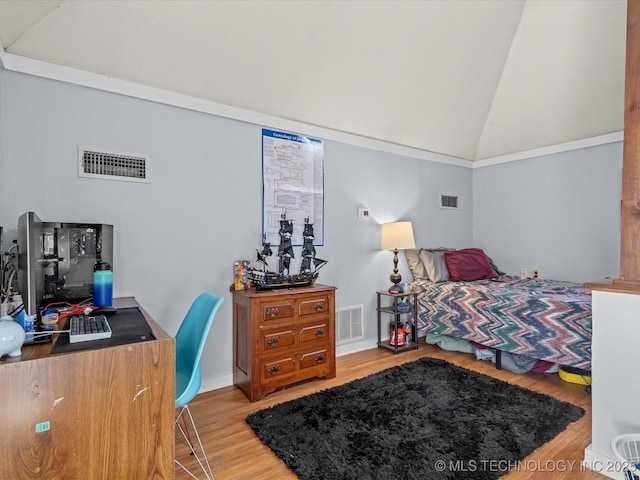 bedroom featuring hardwood / wood-style floors and high vaulted ceiling