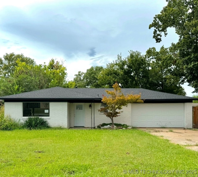 single story home with a front yard and a garage