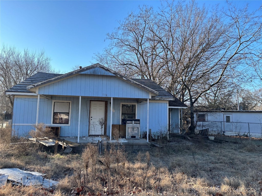 rear view of house featuring a porch