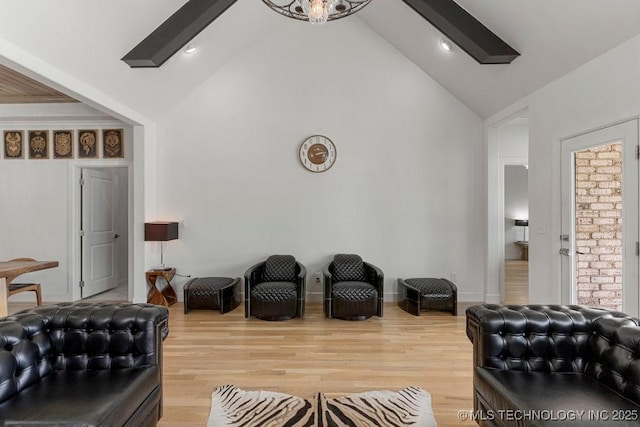 living room featuring wood-type flooring and vaulted ceiling