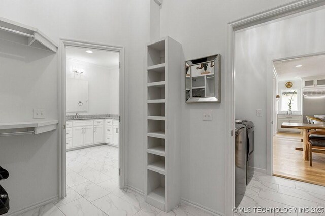 walk in closet featuring washer and clothes dryer and sink