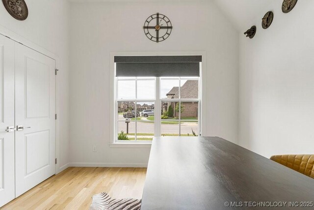 interior space with light hardwood / wood-style flooring and vaulted ceiling