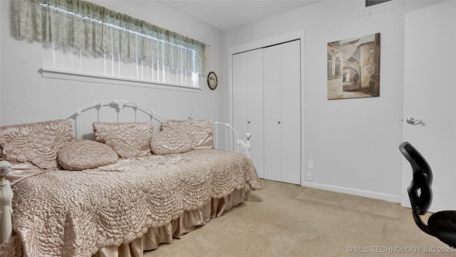 bedroom with a closet and carpet floors