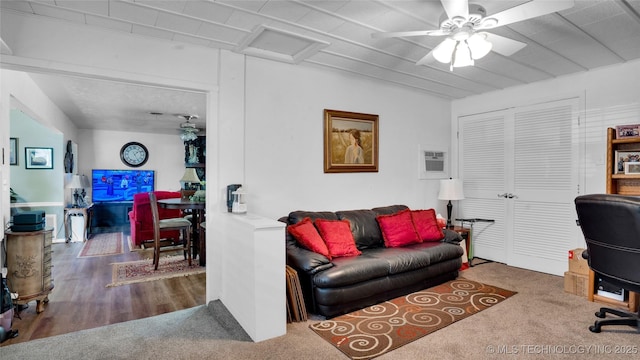 carpeted office space with a wall unit AC and ceiling fan