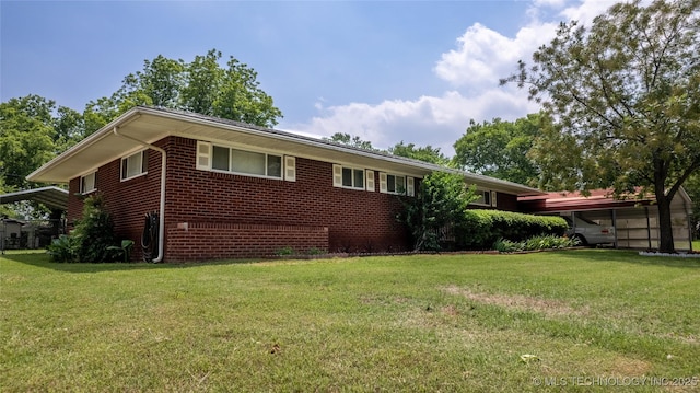 view of side of property with a yard and a carport