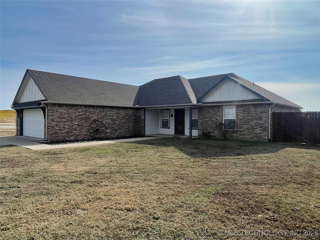 single story home with a front yard and a garage