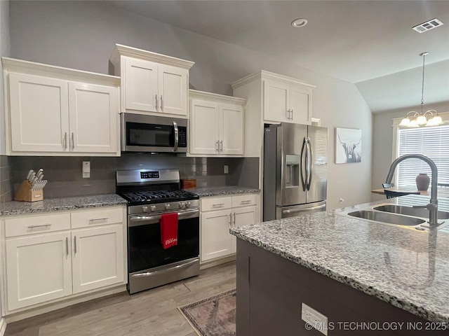 kitchen featuring decorative backsplash, sink, white cabinetry, and stainless steel appliances