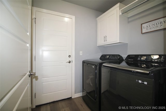 washroom with cabinets, dark hardwood / wood-style floors, and washer and dryer