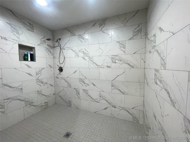 bathroom with a tile shower