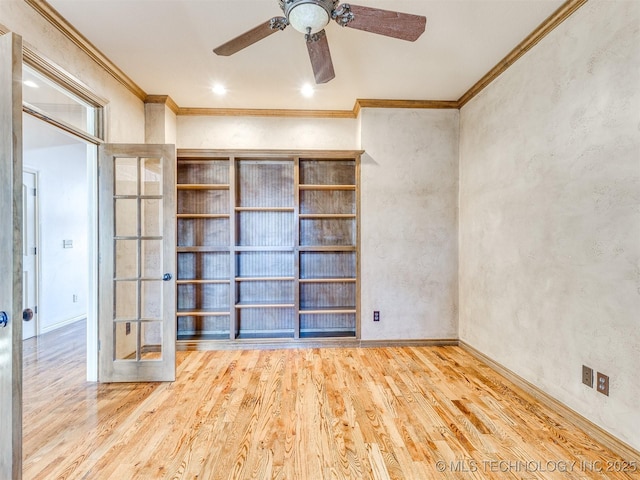 empty room with ceiling fan, wood-type flooring, crown molding, and french doors