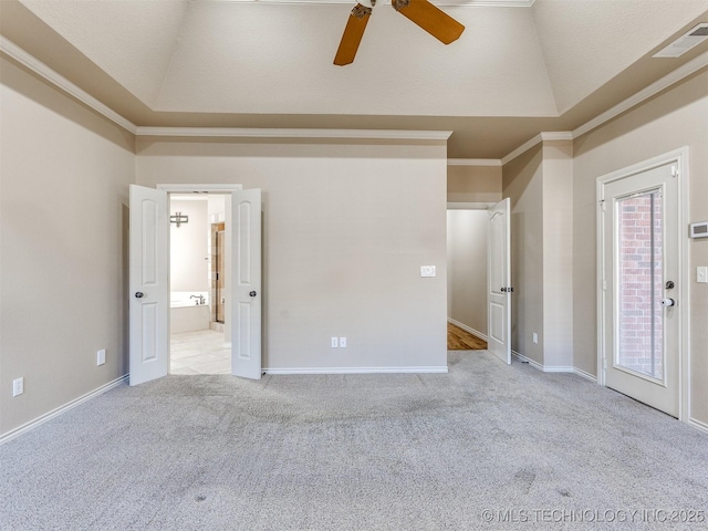 carpeted empty room with ceiling fan, ornamental molding, and a tray ceiling