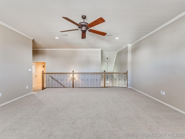 empty room featuring ceiling fan, crown molding, and light carpet